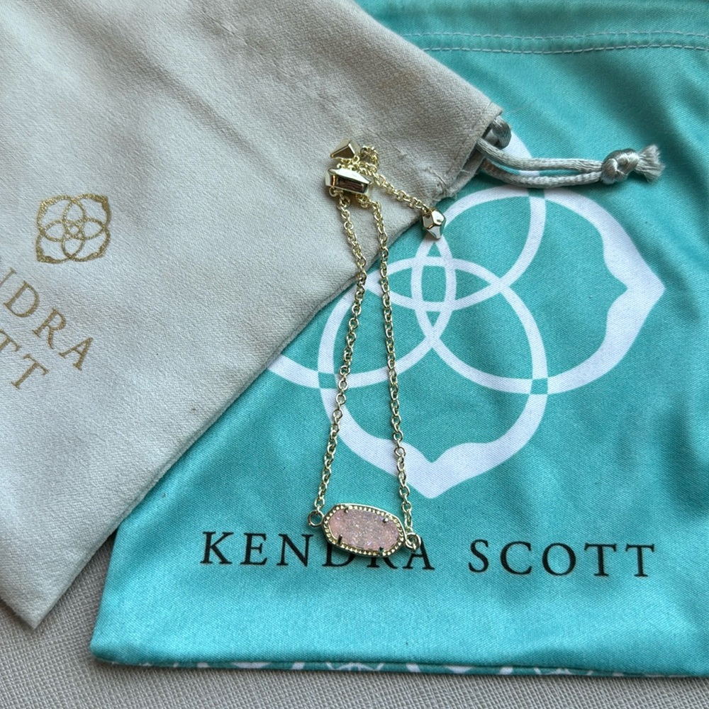 Gold and pink Kendra Scott bracelet.